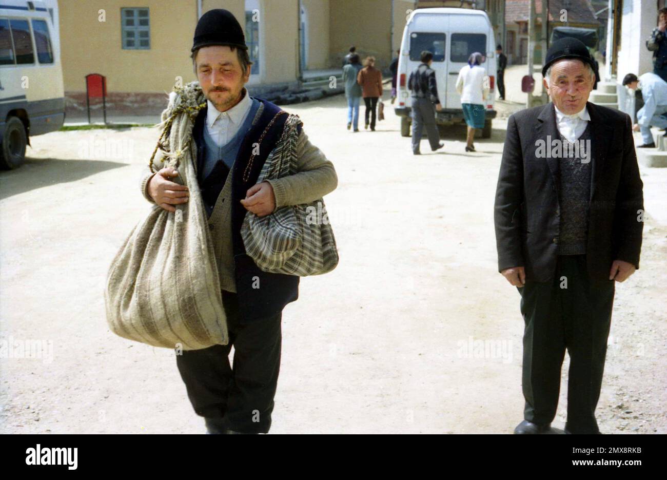 Sibiu County, Rumänien, ca. 1999. Männer in einer Dorfstraße in ihrer Sonntagskleidung und tragen traditionelle Wollhüte. Stockfoto