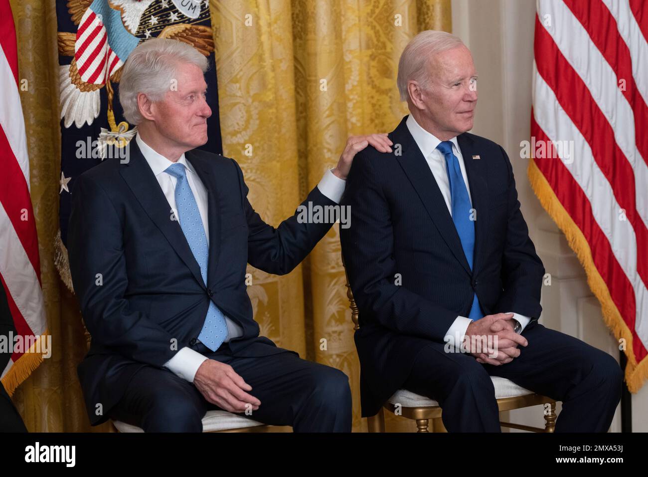 Der ehemalige US-Präsident Bill Clinton legt seine Hand auf die Schulter des US-Präsidenten Joe Biden während einer Zeremonie anlässlich des 30. Jahrestags des Family and Medical Leave Act im Weißen Haus in Washington, DC am 2. Februar 2023. Kredit: Chris Kleponis/CNP/MediaPunch Stockfoto