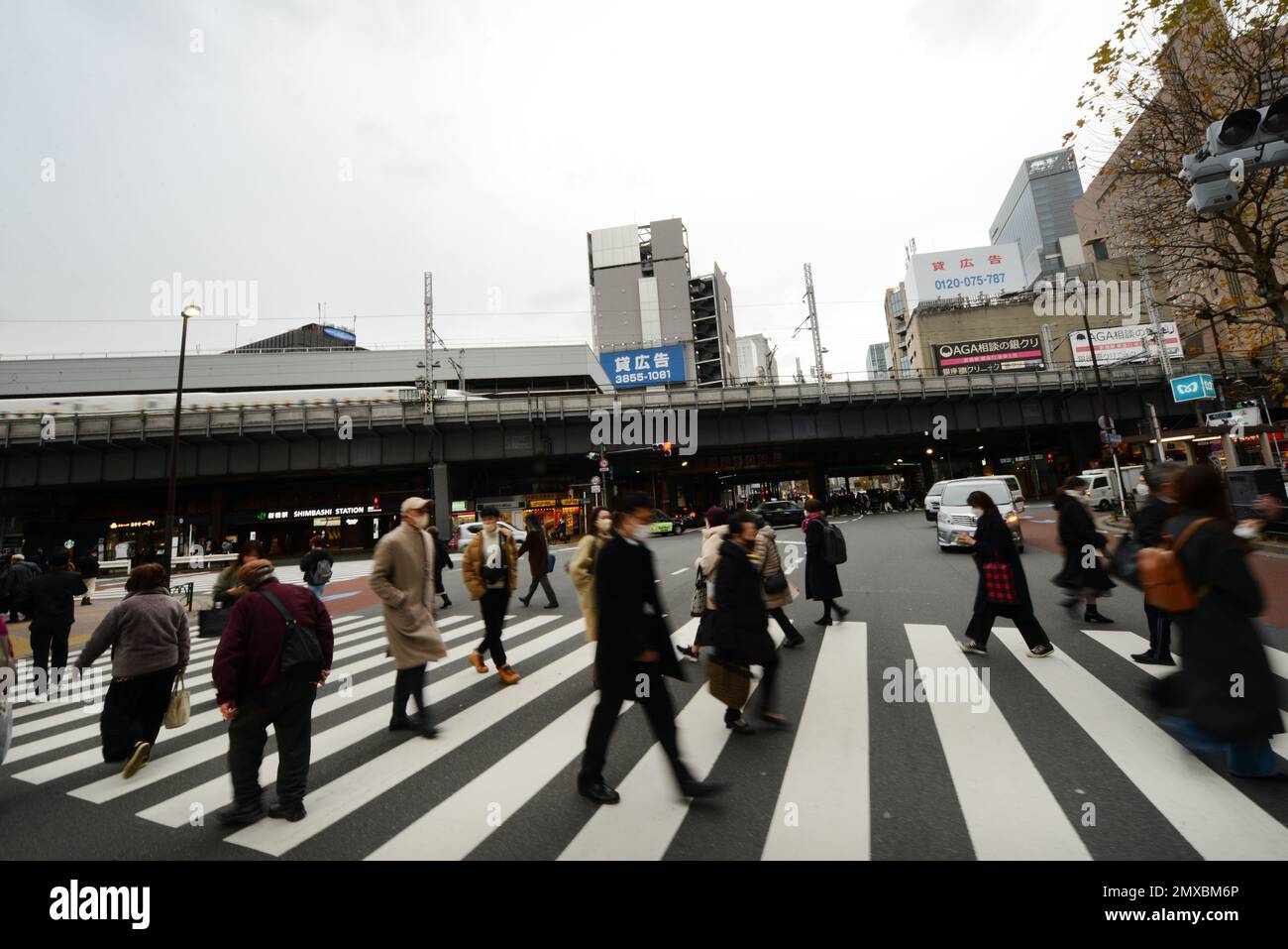 Fußgänger, die die Straße überqueren in Shimbashi, Tokio, Japan. Stockfoto