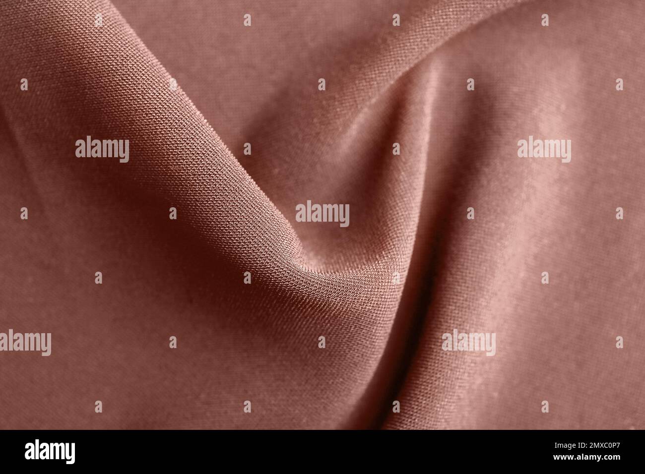 Textil in Rosengold als Hintergrund, Nahaufnahme Stockfoto