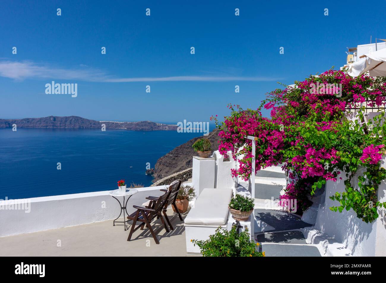 Romantische mediterraen Urlaub Dachterrasse über dem Meer in Santorin mit Bougainvillea Blume. Stockfoto