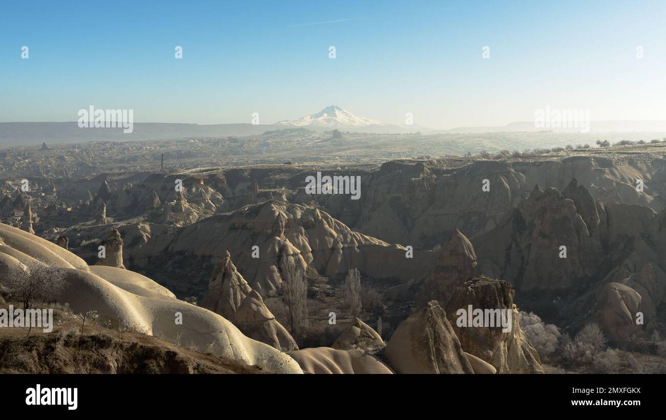 Panoramablick auf Kappadokien, Ürgüp, Nevşehir, Türkei. Erciyes Mountain am Horizont, einer der höchsten Berge in der Türkei. Klarer blauer Himmel. Stockfoto
