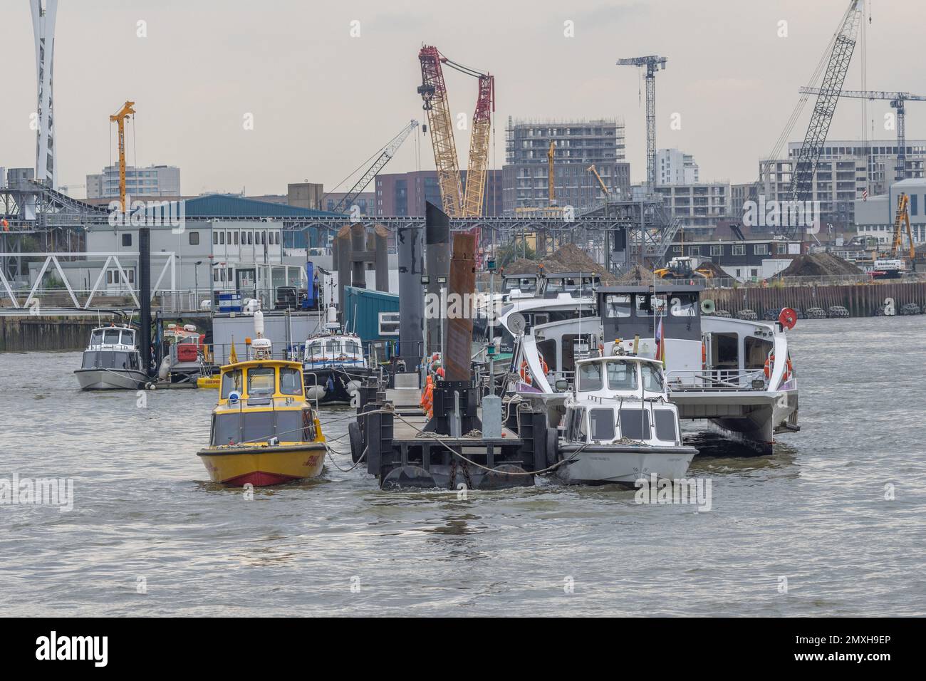 Die Boote treiben auf dem Wasser an einem Dock in der Nähe einer Stadt Stockfoto