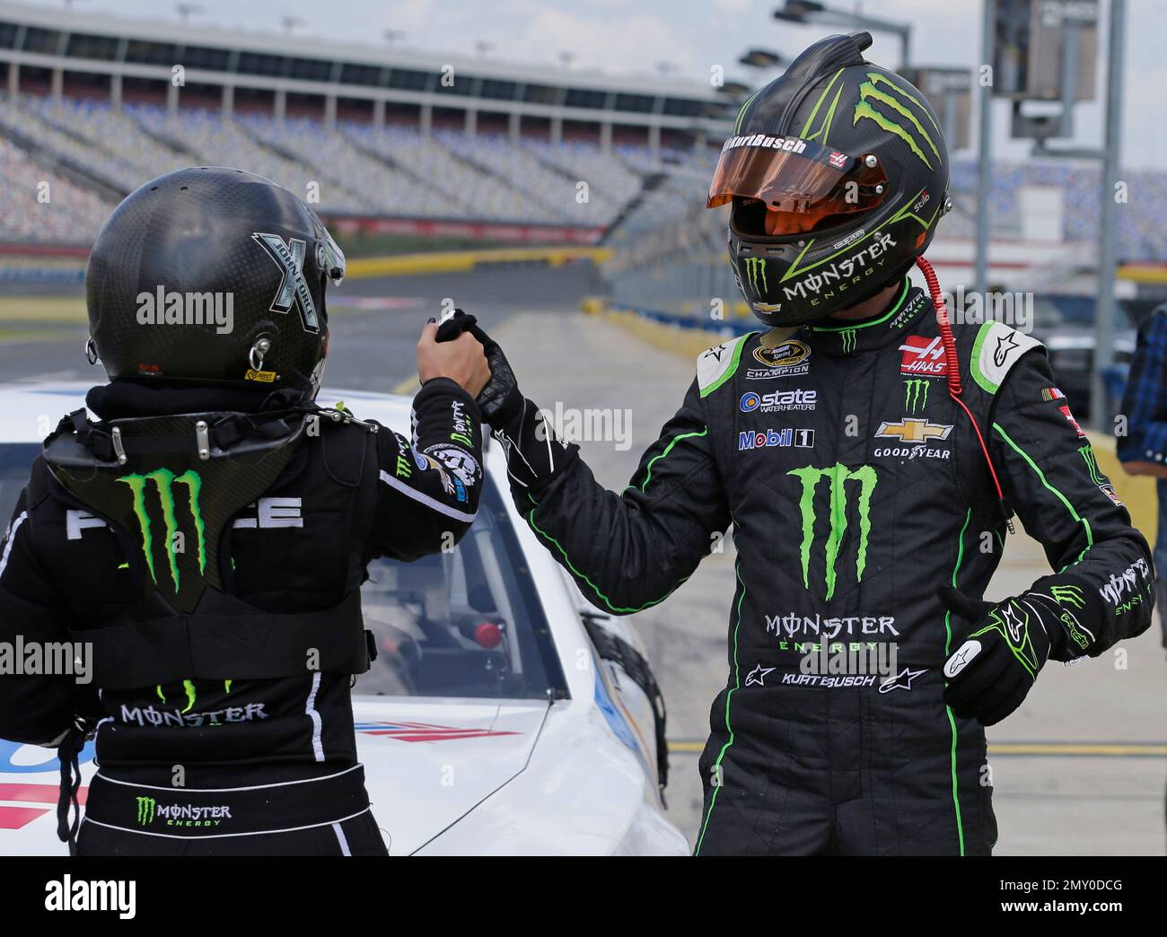 NASCAR driver Kurt Busch, right, high fives NHRA drag racer Brittany Force, left, after taking a race car for laps around Charlotte Motor Speedway in Concord, N.C., during a news conference Wednesday, Sept. 7, 2016. The drivers raced identical Chevrolet Camaro's before Busch drove Force around the race track. (AP Photo/Chuck Burton) Stockfoto