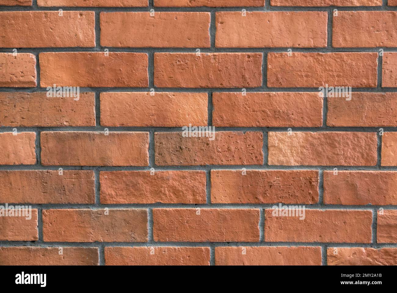 Rötlich-brauner Backsteinhintergrund. Stockfoto