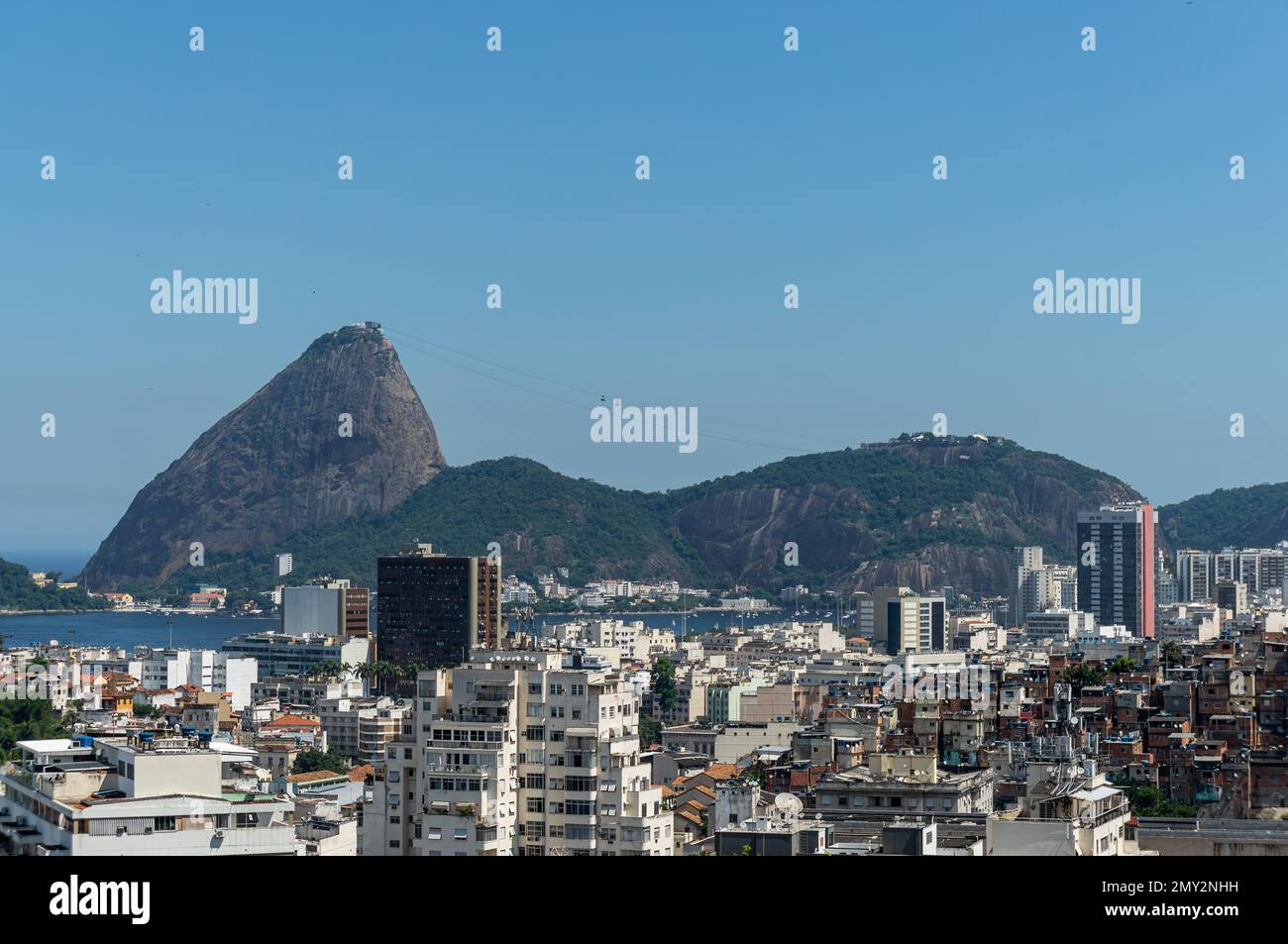 Blick auf die Stadt Rio de Janeiro mit dem Zuckerhut und dem Urca-Hügel hinten unter dem sonnigen blauen Himmel. Vom Blickpunkt Curvelo aus betrachtet. Stockfoto