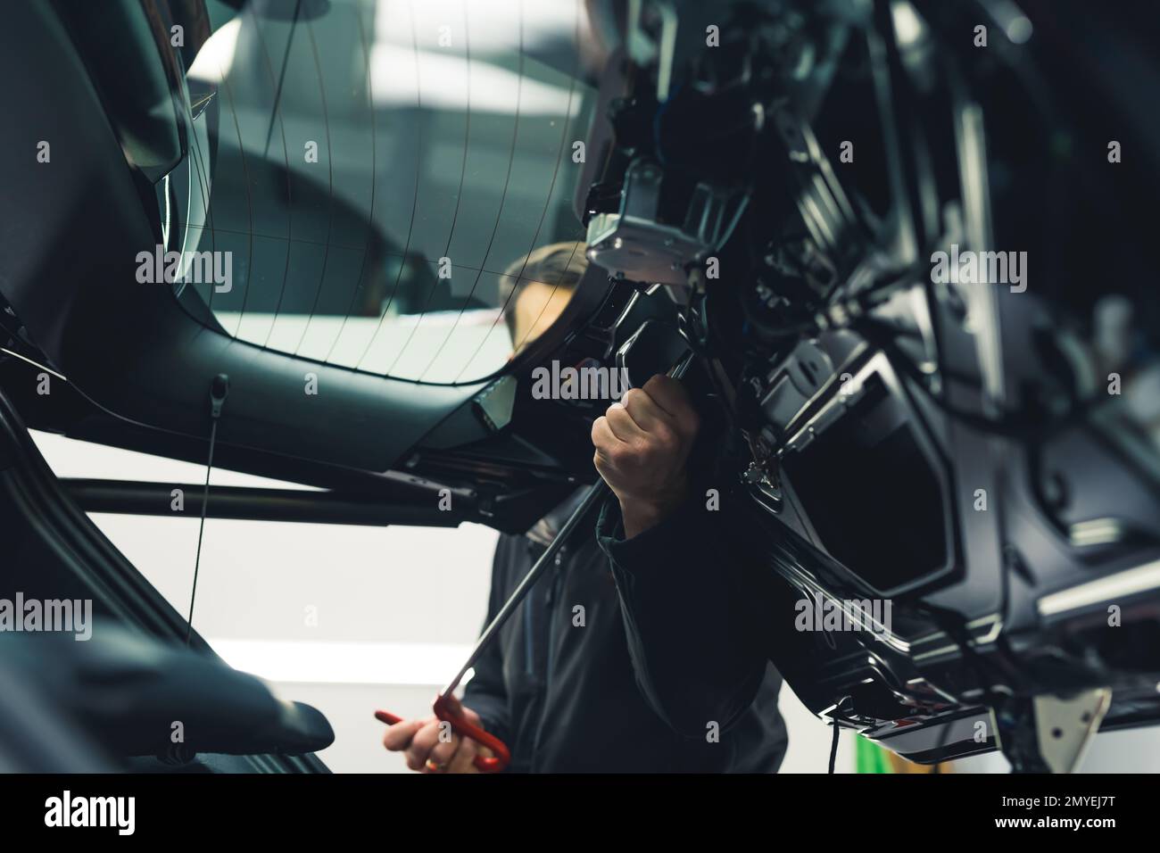 Autokarosserie arbeitet lackfreie Ausbeultechnik. Innerhalb der Lkw-POV. Mechaniker- und Fahrzeugdetails. Hochwertiges Foto Stockfoto