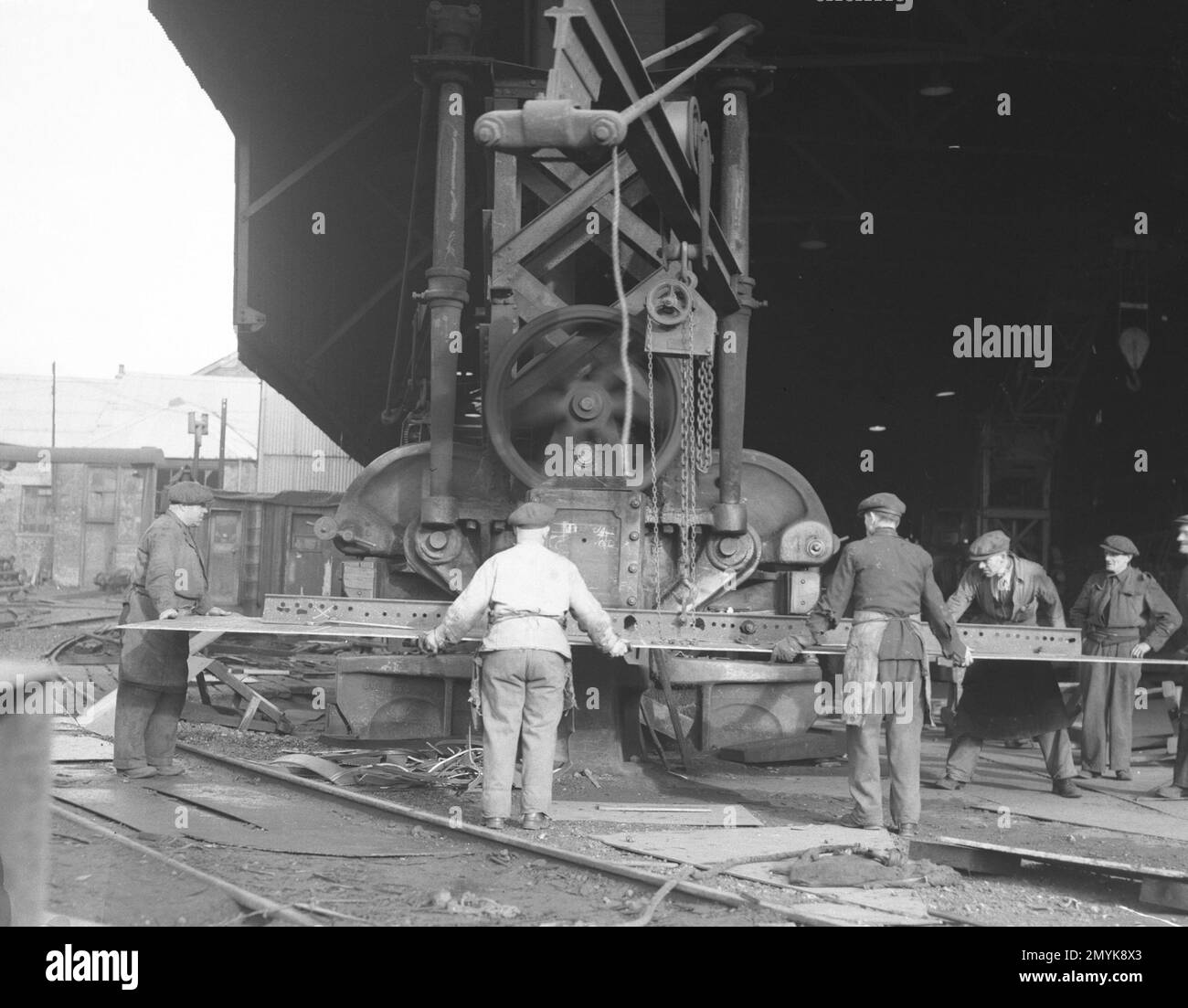 A giant punch makes rivet holes in a steel sheet in the Cleland