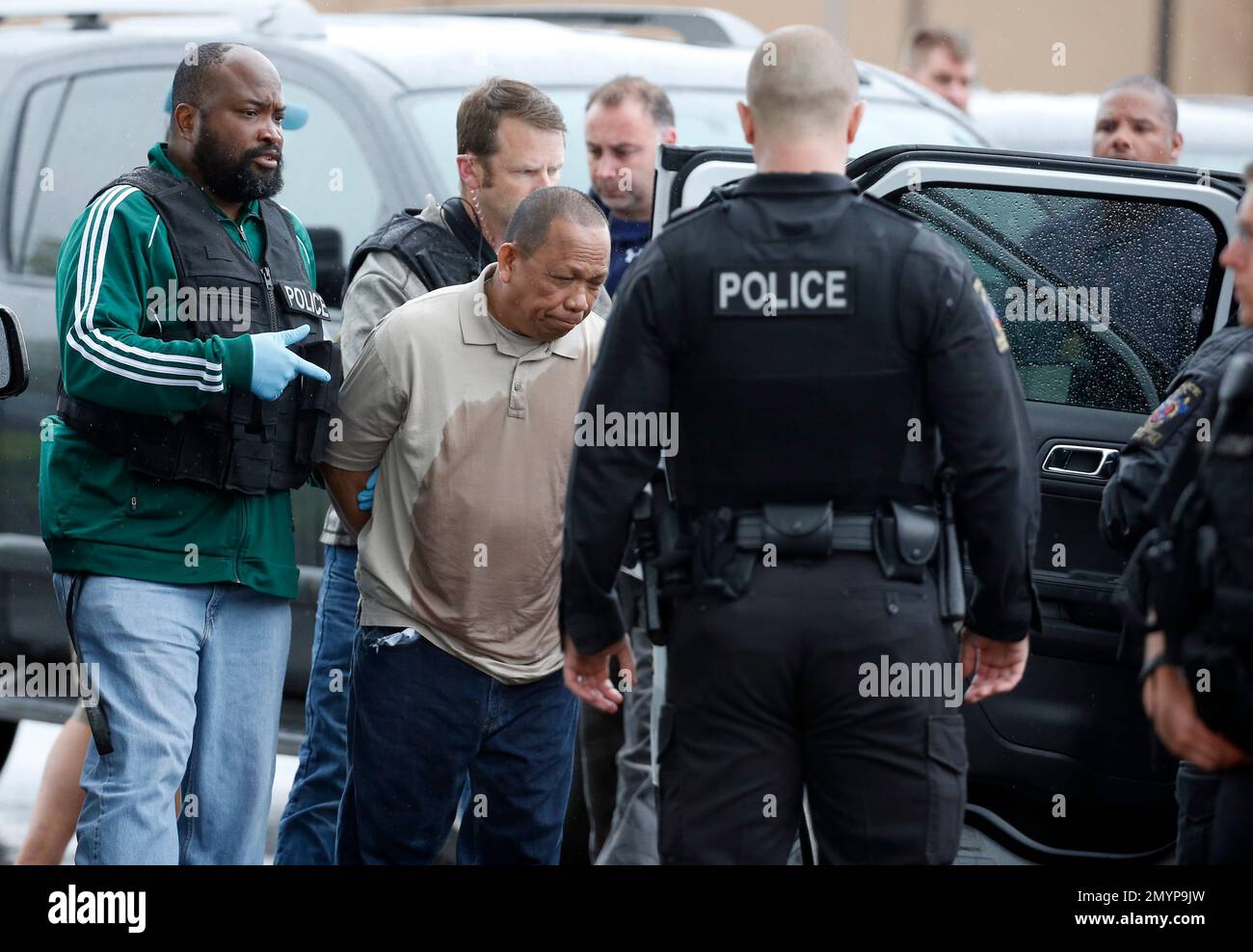 Police take Eulalio Tordil, 62, center, a suspect in three fatal