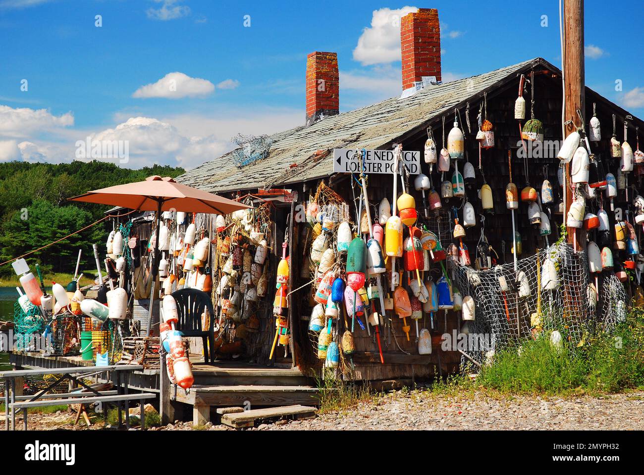 Eine Hummerhütte an der Küste von Maine ist mit bunten Bojen dekoriert Stockfoto