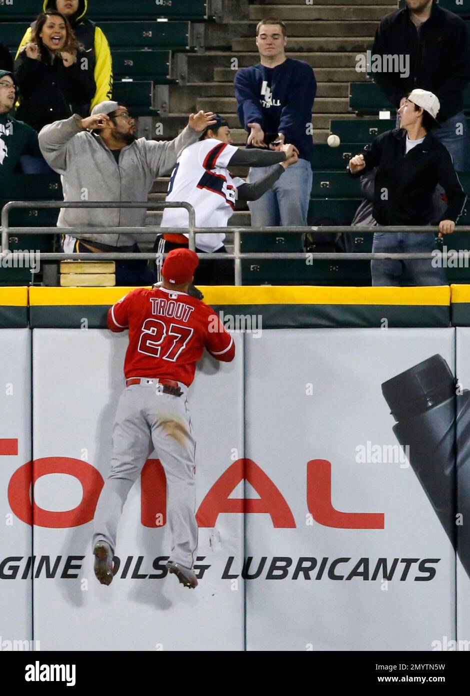 Los Angeles Angels center fielder Mike Trout watches fans catch a home