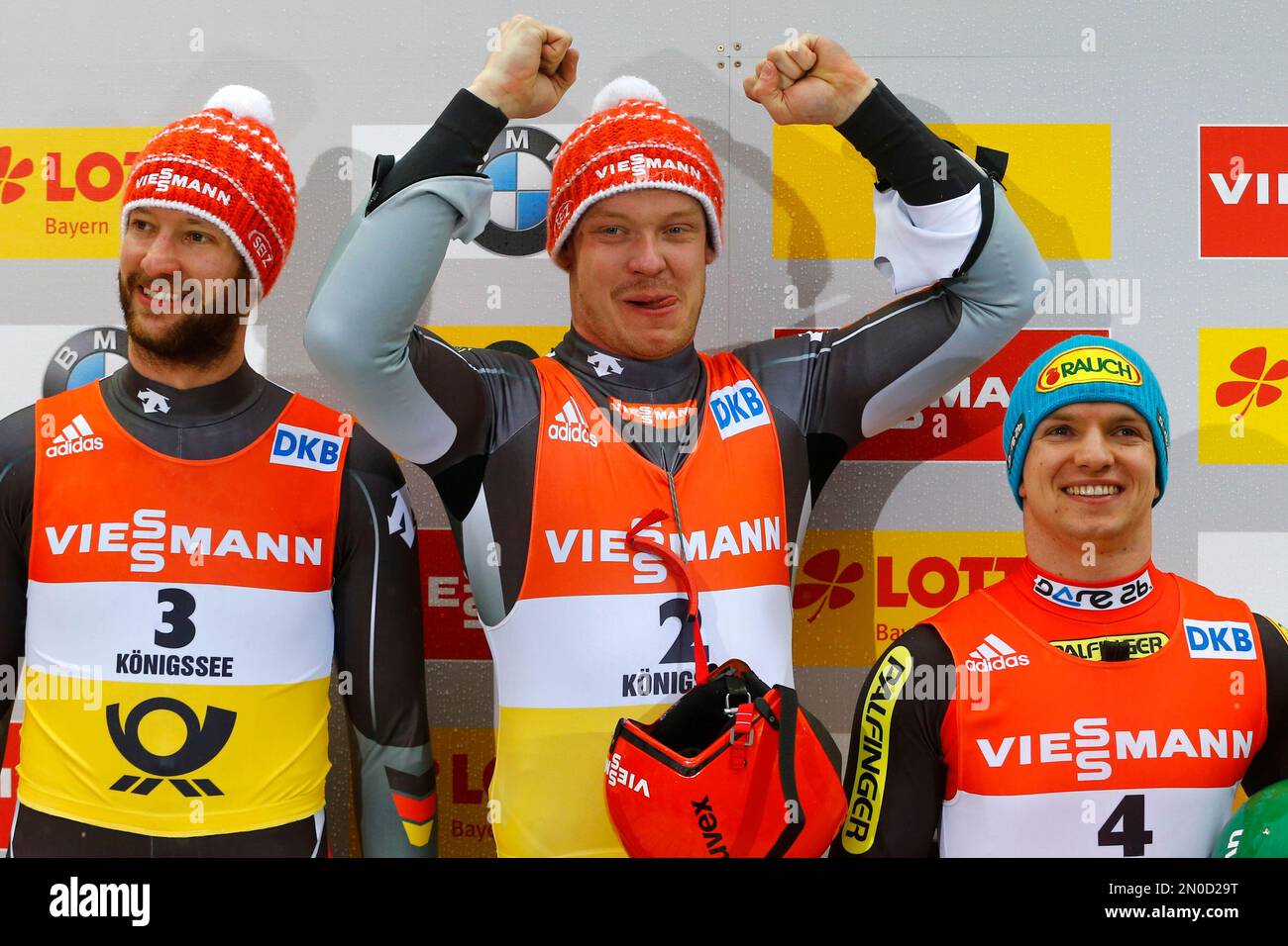 Winner Germany's Felix Loch, center, celebrates on the podium besides second placed German Ralf Palik, left, and third placed Austrian Wolfgang Kindl at the men's luge World Championships race in Koenigssee, Germany, Sunday, Jan. 31, 2016. (AP Photo/Matthias Schrader) Stockfoto
