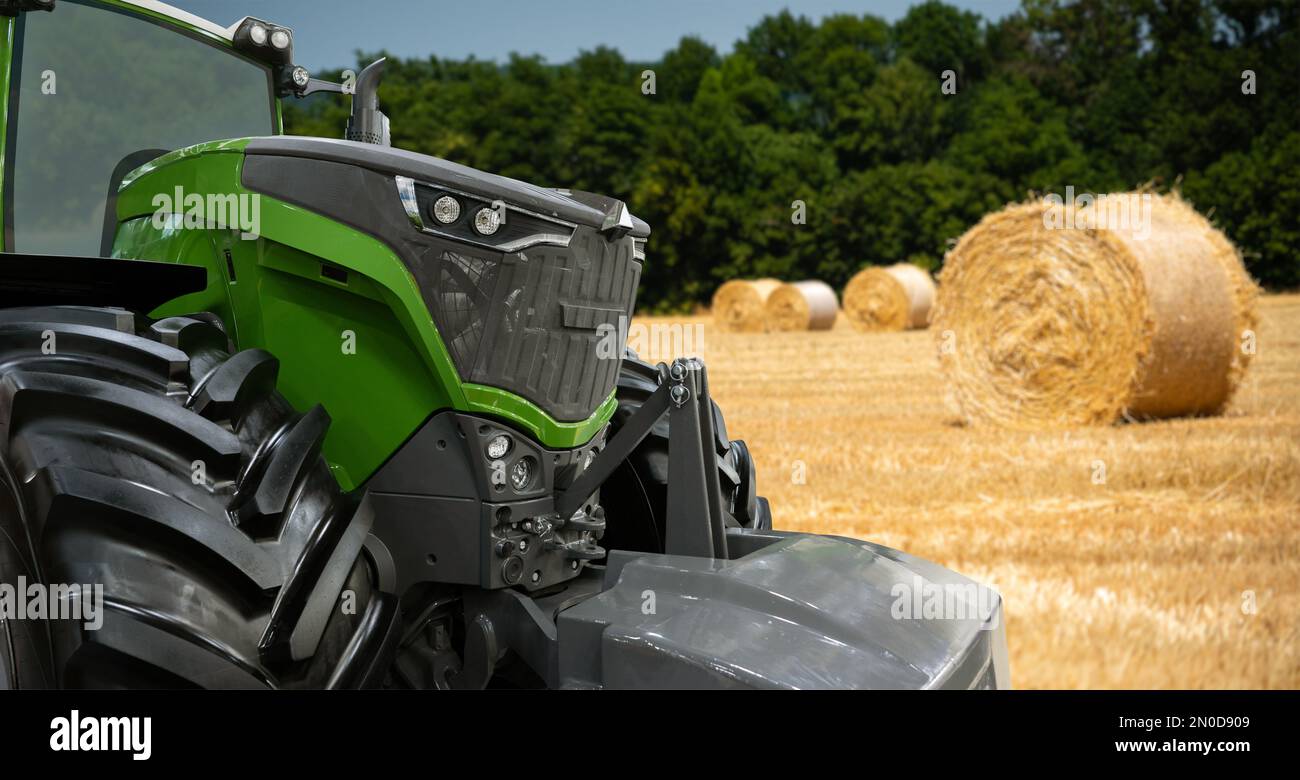 Landwirtschaftlicher Traktor auf dem Hintergrund von Strohballen Stockfoto