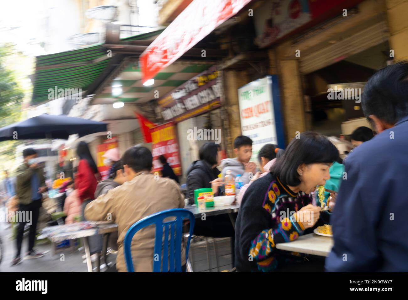 Hanoi, Vietnam, Januar 2023. Leute, die in einem Street Food Restaurant im Stadtzentrum essen Stockfoto