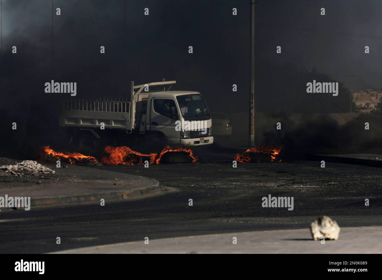 Road Execution A truck approaches burning tires blocking a road during a third ...