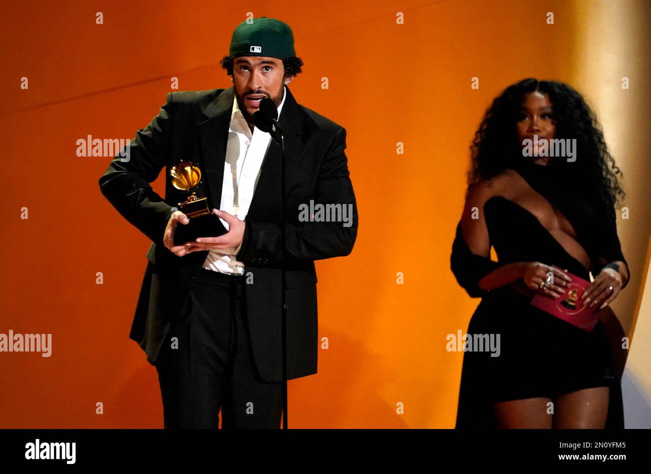 Bad Bunny, left, accepts the award for best musica urbana album for "Un(00)