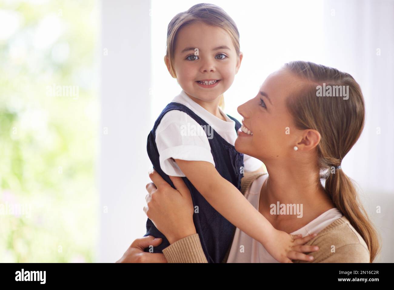 Jeden Moment genießen. Porträt einer jungen Mutter und ihres kleinen Mädchens, die sich zu Hause anfreunden. Stockfoto