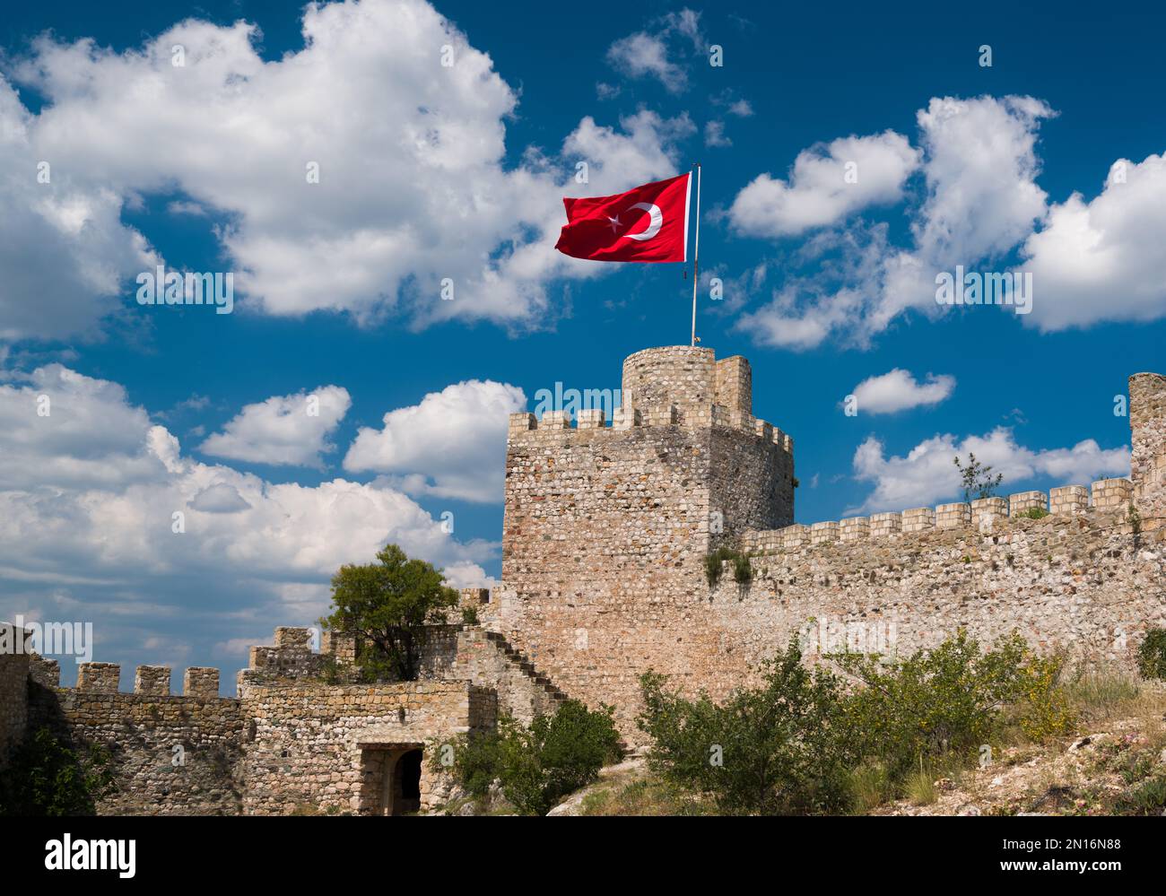 Historisches türkisches Schloss und türkische Flagge. Türkische Flagge und Schloss am Himmel an einem wunderschönen Tag. Stockfoto