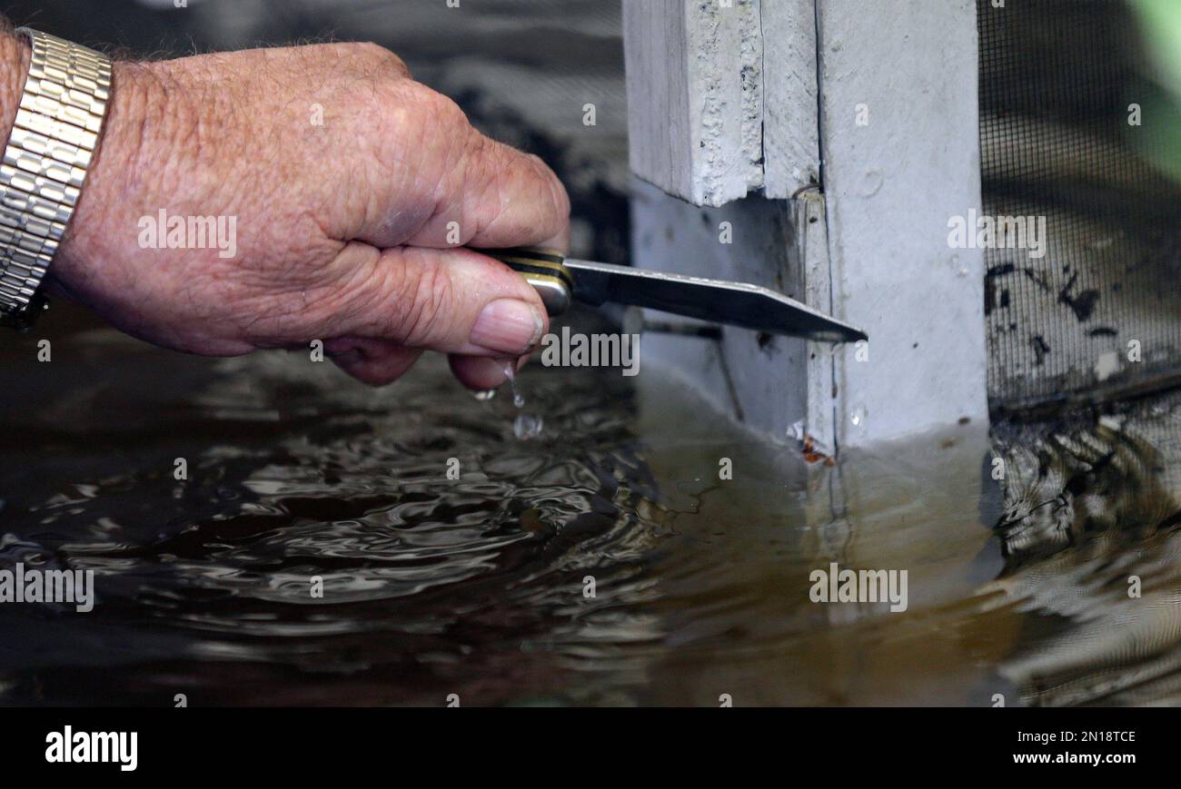 Florence, S.C. resident Jackie Lee makes a notch to mark the highwater
