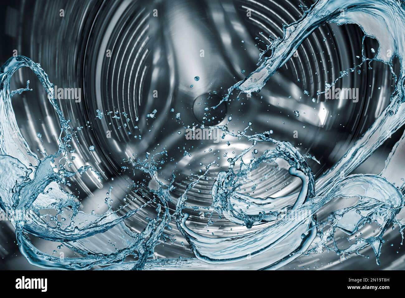 Waschmaschinentrommel mit Spritzwasser. Stockfoto