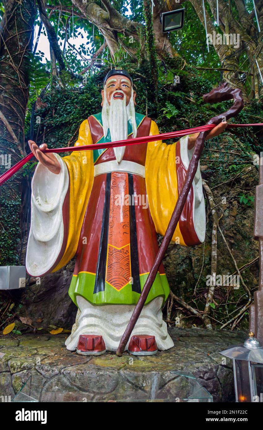 Seremban, Malaysia; Centipede-Tempel, buddhistischer Tempel, Statuen, die die acht Unsterblichen (Xian) darstellen, die auf Felsen inmitten der Bäume sitzen. Stockfoto