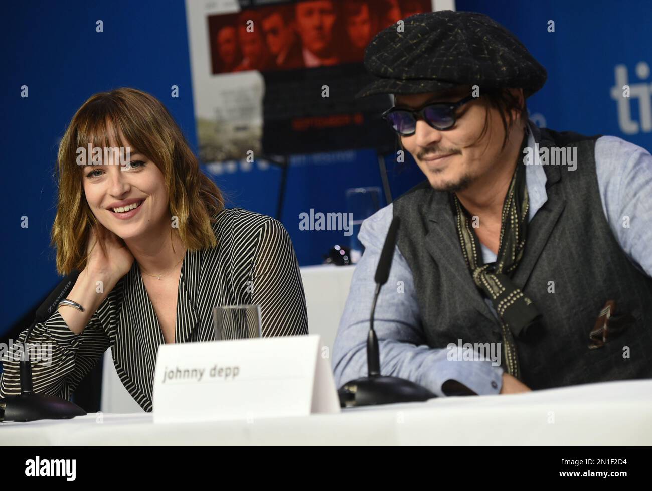 Actress Dakota Johnson, left, and Johnny Depp attend the press