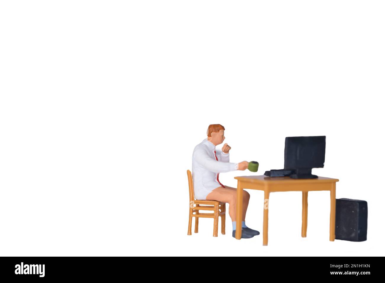 Ein Mann sitzt am Schreibtisch im Heimbüro, isoliert auf weißem Hintergrund Stockfoto