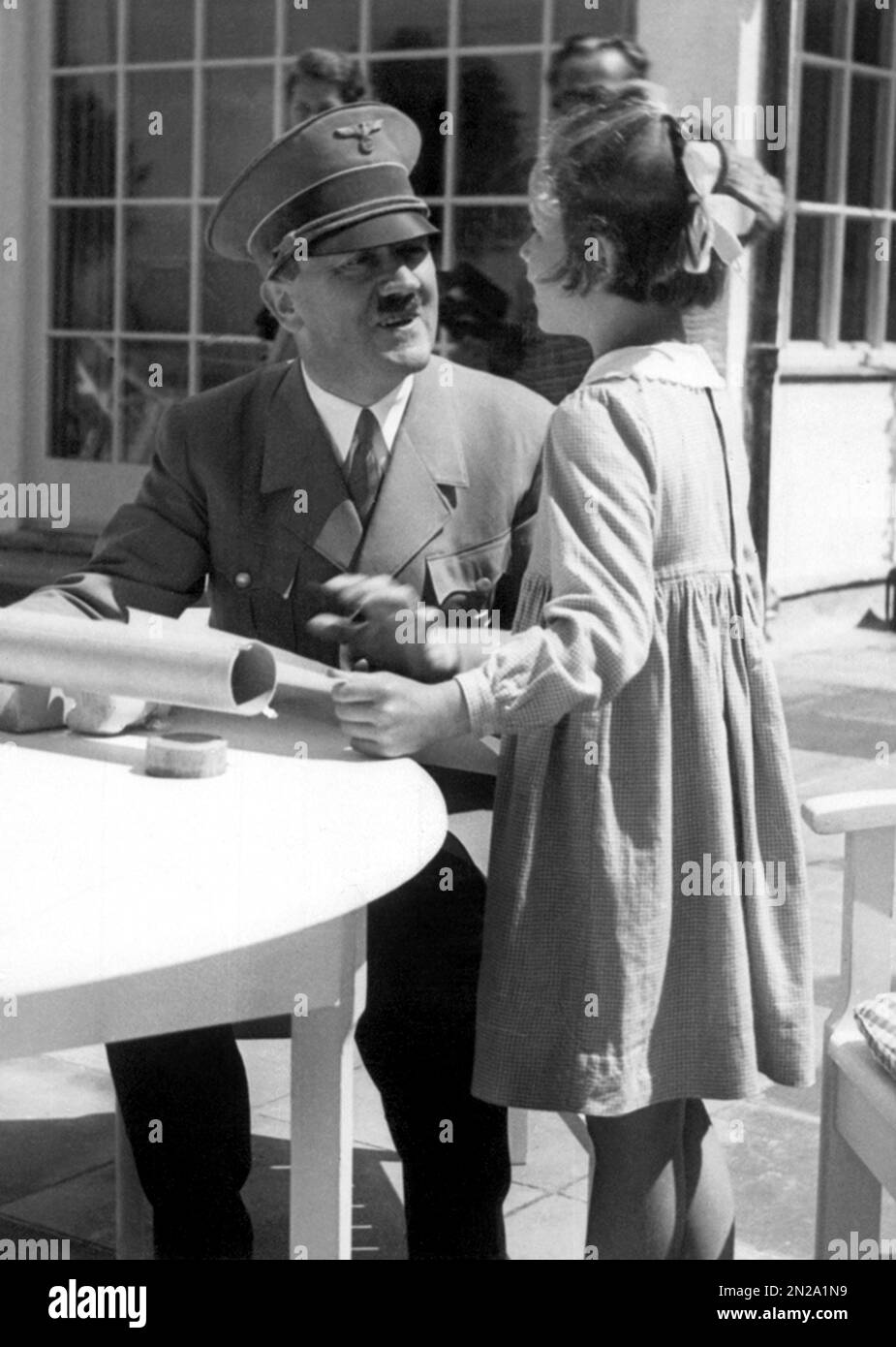 1934 Ca , Berghof , Obersalzberg , Bayern , DEUTSCHLAND : der Nazi-deutsche Führerdiktator ADOLF HITLER ( 1889 - 1945 ) mit einem kleinen Mädchen auf der Terrasse des Hauses Wachenfeld . Dieses Kind hieß Rosa Bernile Nienau ( 1926 - 1943 ) und war ein Kind jüdischen Ursprungs . Foto in den persönlichen Alben von Eva Baun gefunden. Unbekannter Fotograf. - GESCHICHTE - FOTO STORICHE .- Zweiter Weltkrieg - NAZI - NAZIST - NAZISMUS - NAZISTA - NAZISMO - SECONDA GUERRA MONDIALE - WW2 - ZWEITER WELTKRIEG - Dittatore - POLITICA - POLITICA - POLITICO - Bambina - Kind - Kinder - Bambini - KINDHEIT - KINDHEIT - KINDHEIT - LÄCHELN - sorriso -- - Archivio GBB Stockfoto