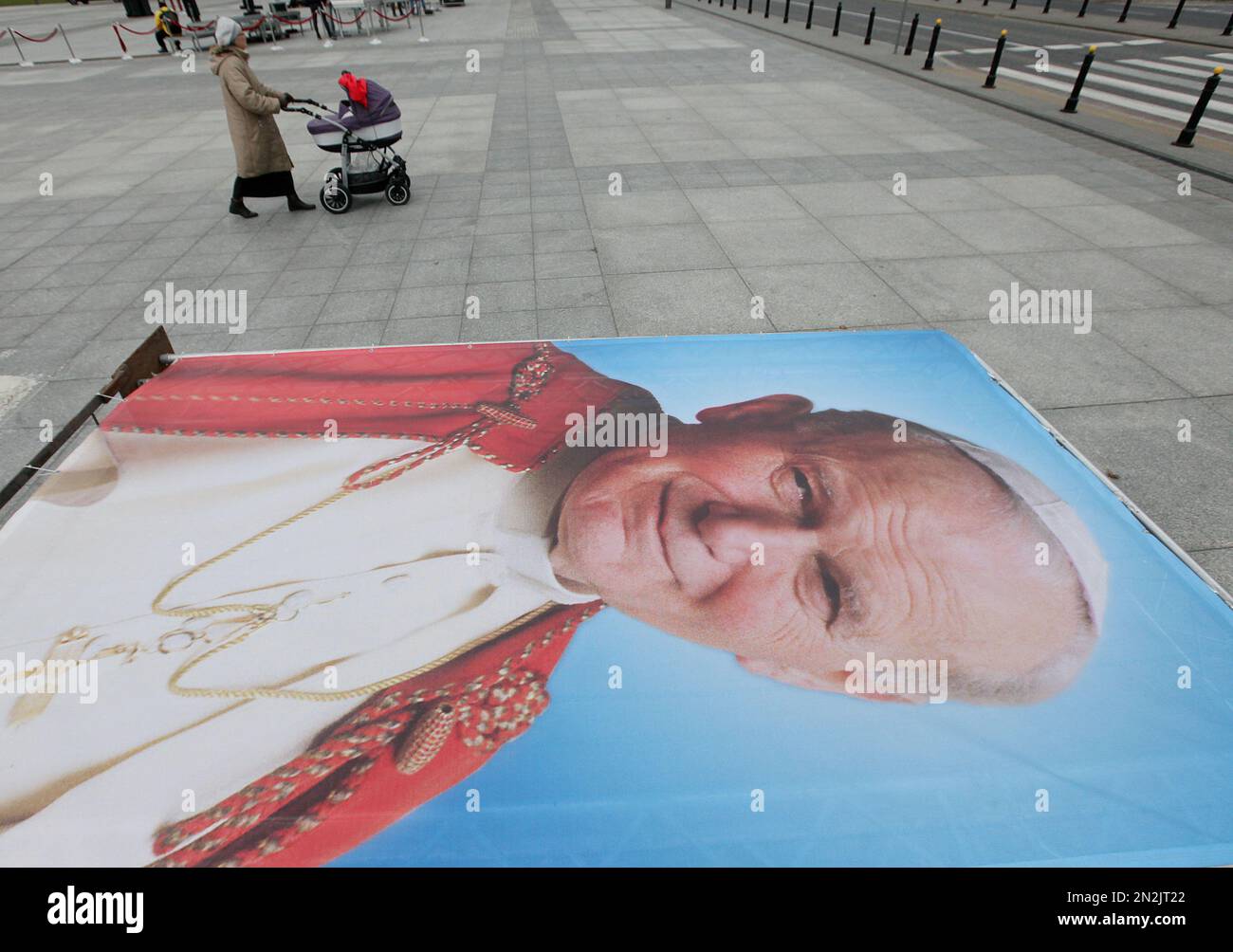 A large poster of late Pope John Paul II is laid out as Roman Catholic