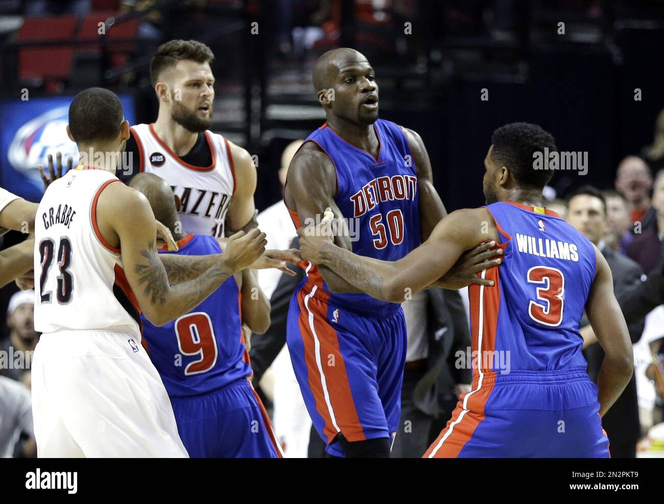 Detroit Pistons forward Shawne Williams, right, is held back by