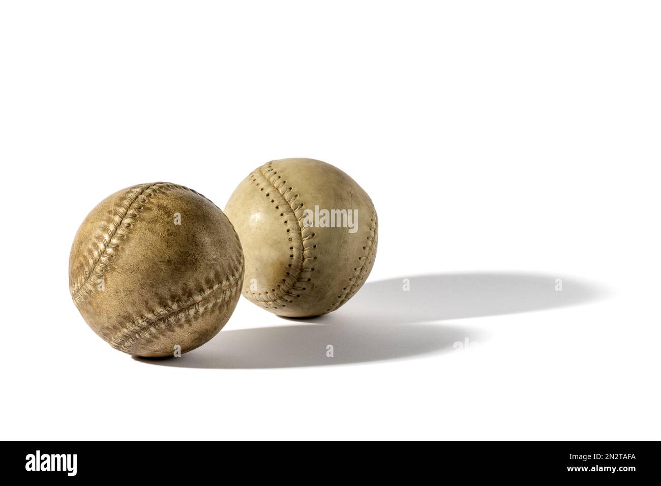 Zwei Baseballs im Retro-Look aus schäbigem Leder mit Schatten auf weißem Hintergrund Stockfoto