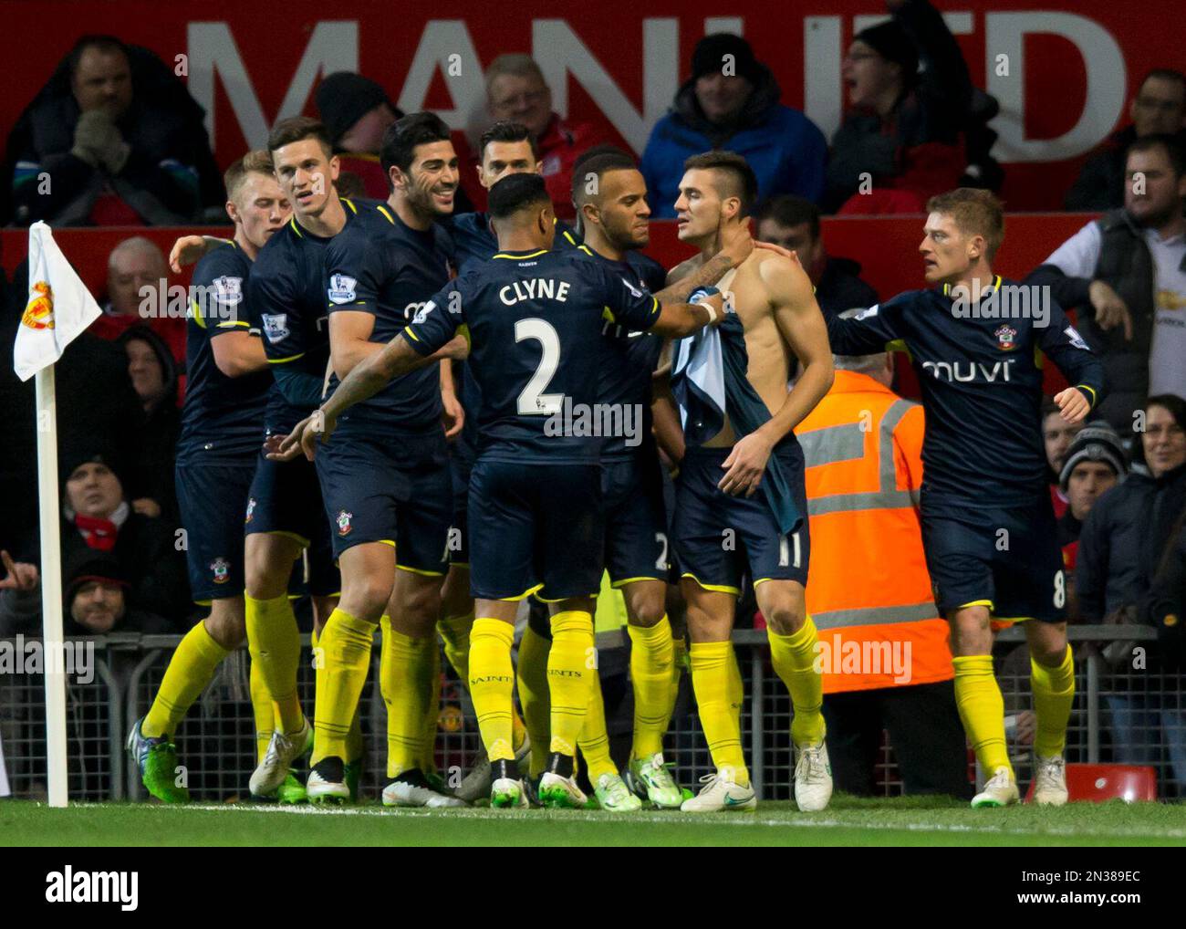 Southampton's Dusan Tadic, centre right, celebrates with teammates after scoring during the English Premier League soccer match between Manchester United and Southampton at Old Trafford Stadium, Manchester, England, Sunday Jan. 11, 2015. (AP Photo/Jon Super) Stockfoto
