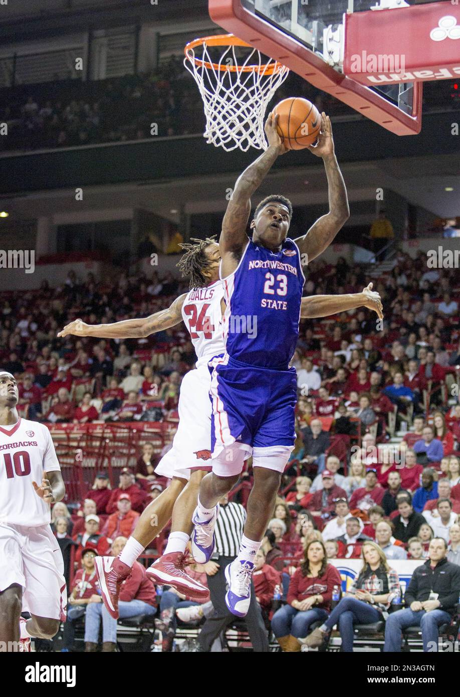 Northwestern State guard Zeek Woodley, front, leaps for a layup as