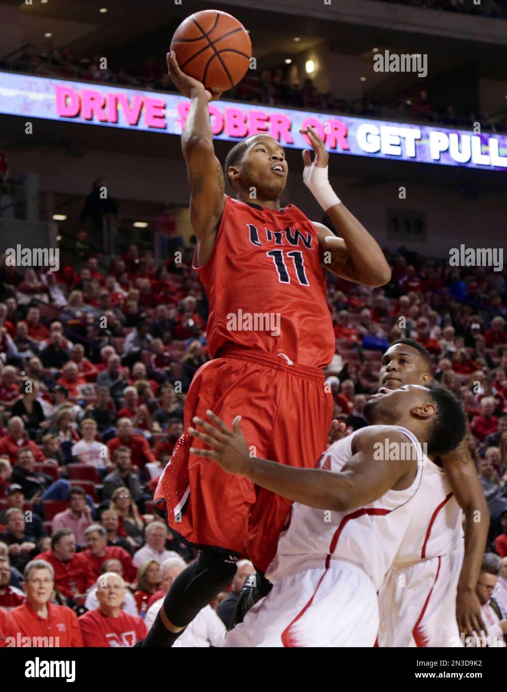 Incarnate Word's Denzel Livingston (11) shoots over Nebraska's Benny Parker (3) during the second half of an NCAA college basketball game in Lincoln, Neb., Wednesday, Dec. 10, 2014. Incarnate Word won 74-73. (AP Photo/Nati Harnik) Stockfoto