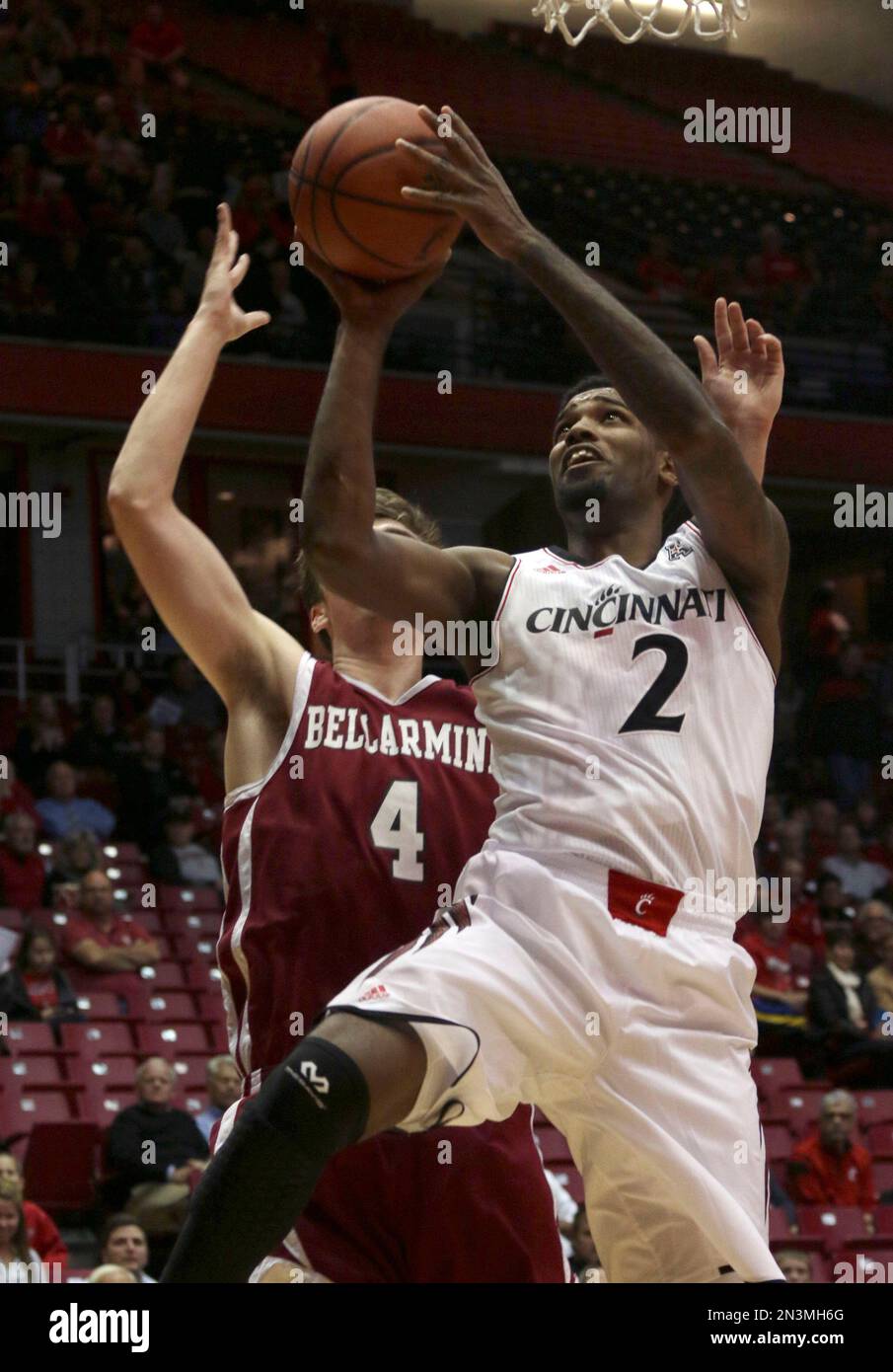 Cincinnati's Octavius Ellis, right, shoots past Bellarmine's