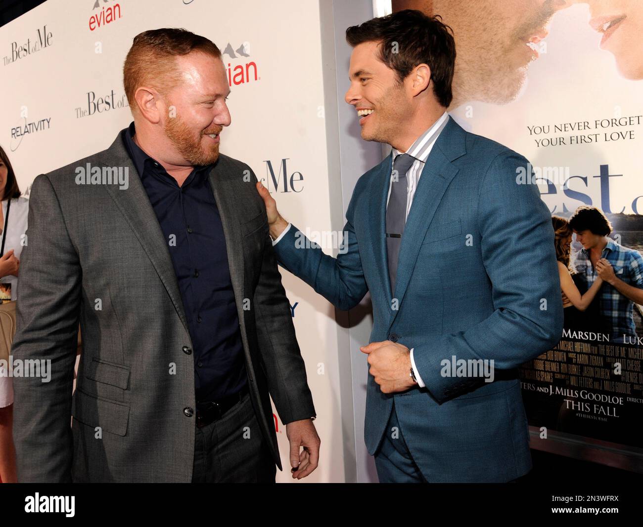 Ryan Kavanaugh, left, founder and CEO of Relativity Media, is greeted by James Marsden, a cast member in "The Best of Me," at the premiere of the film at Regal Cinemas L.A. Live on Tuesday, Oct. 7, 2014, in Los Angeles. (Photo by Chris Pizzello/Invision/AP) Stockfoto