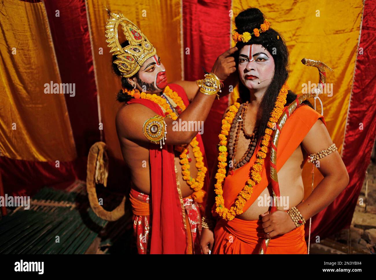 In this Sunday, Sept. 28, 2014 photo, Indian artists prepare themselves ...