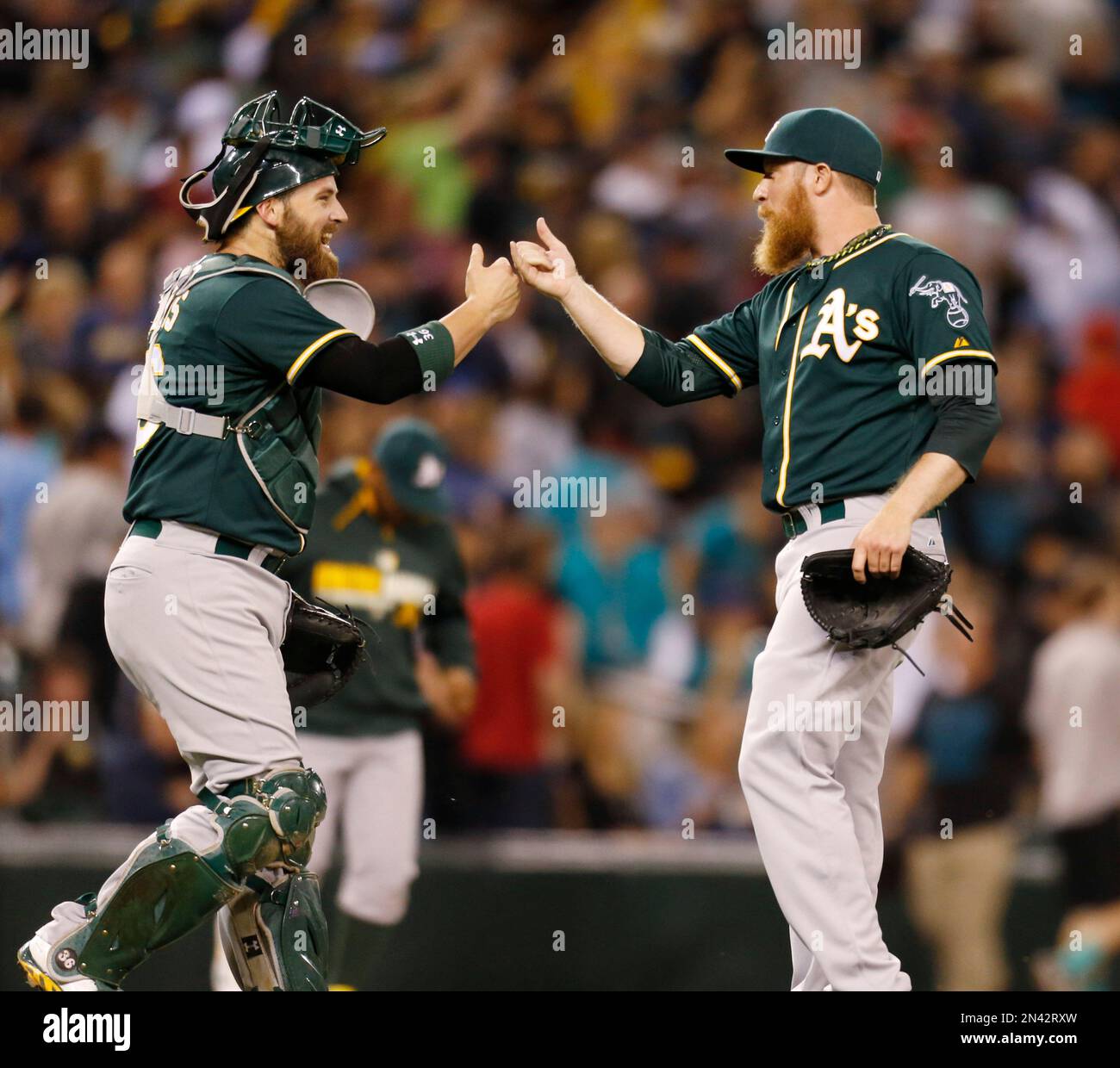 Oakland Athletics catcher Derek Norris congratulates closing pitcher Sean Doolittle after the team's 3-2 win over the Seattle Mariners in 10 innings in a baseball game Saturday, Sept. 13, 2014 in Seattle. (AP Photo/John Froschauer) Stockfoto