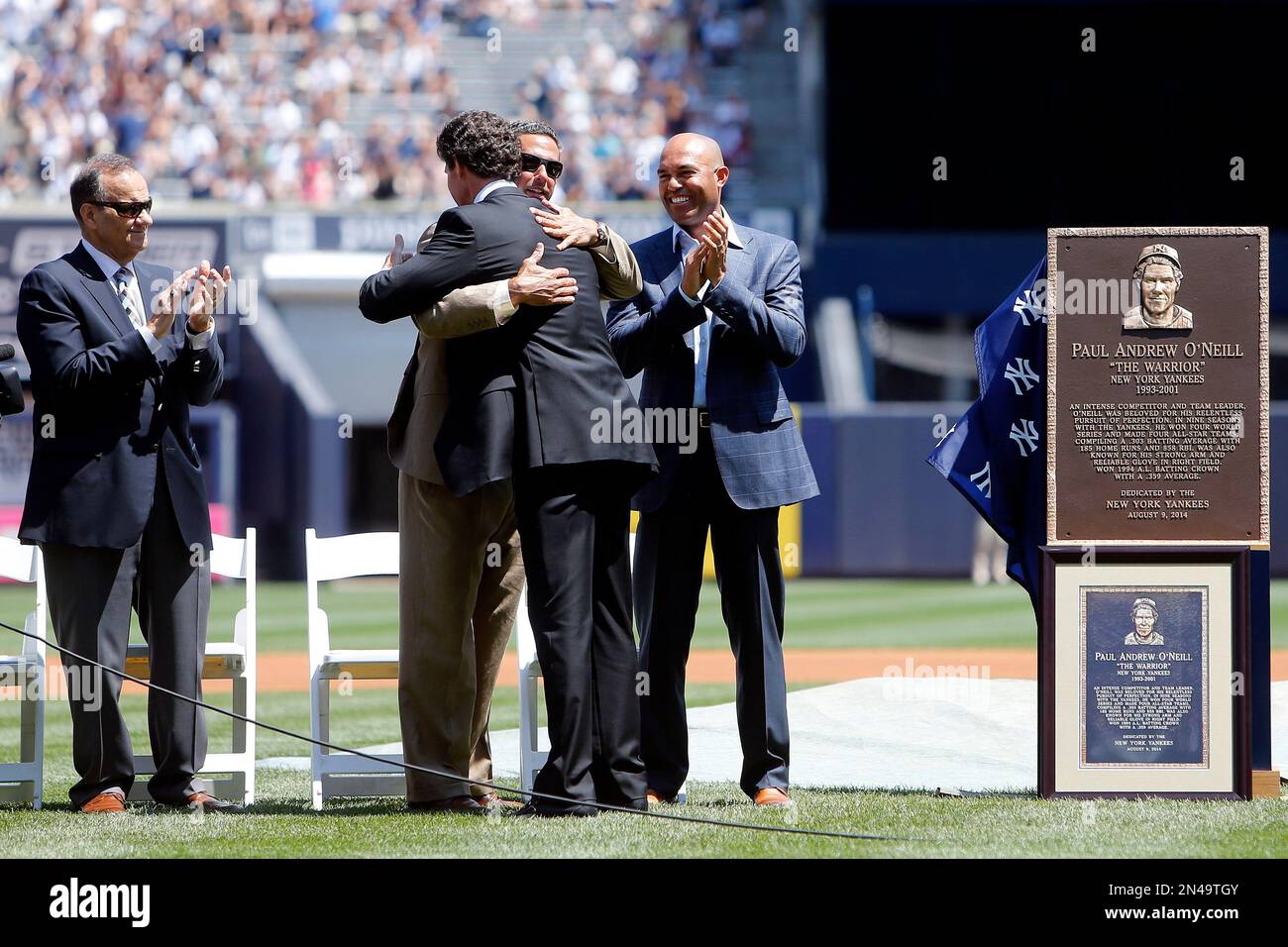 Former New York Yankee player Paul O'Neill, center facing away, is ...