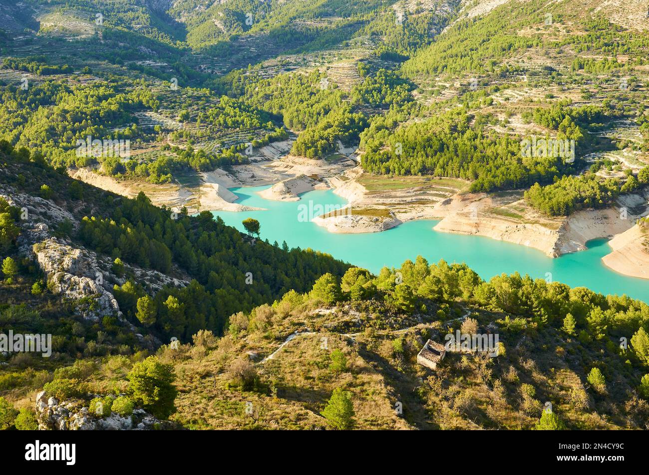 Guadalest Reservoir bei Sonnenuntergang mit seinem charakteristischen türkisfarbenen Wasser (Castell de Guadalest, Marina Baixa, Alicante, Valencian Community, Spanien) Stockfoto