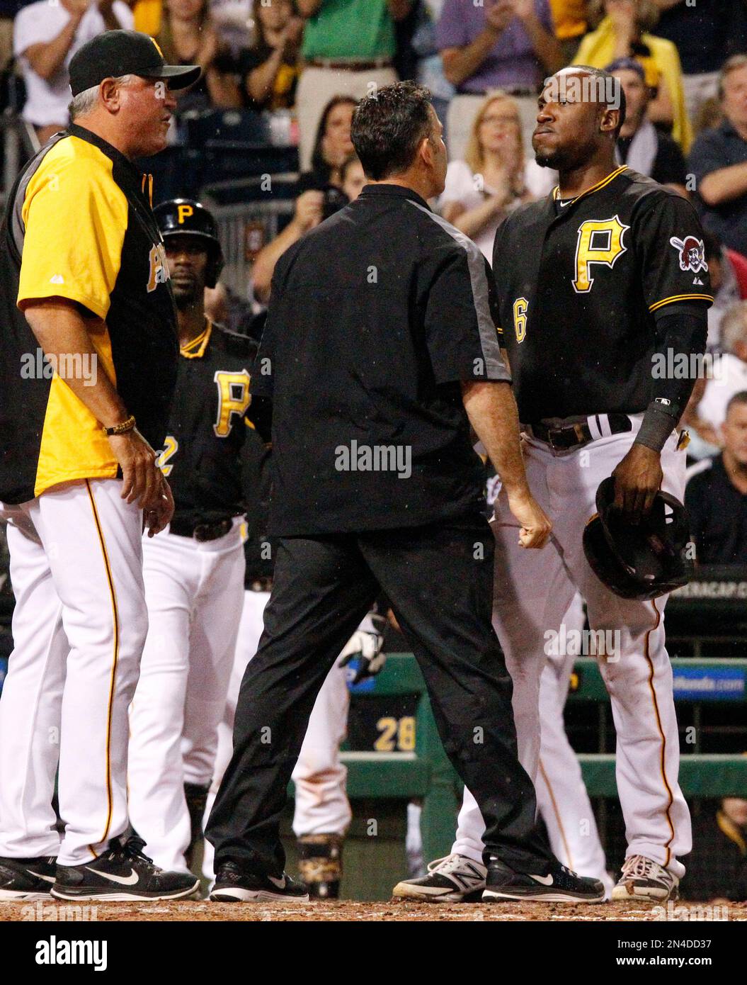Pittsburgh Pirates' Starling Marte, right, is checked by a team trainer as manager Clint Hurdle, left, looks on after being hit in the head by a pitch from Colorado Rockies relief pitcher Adam Ottavino during the seventh inning of a baseball game in Pittsburgh Friday, July 18, 2014. The tying run was forced home by the play and Marte left the game after the inning. The Pirates won 4-2. (AP Photo/Gene J. Puskar) Stockfoto