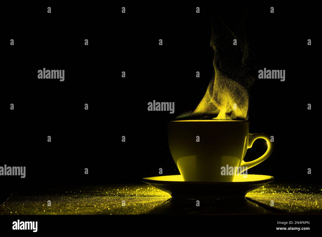 Eine Tasse mit einem warmen Getränk und Dampf, beleuchtet durch gelbes Licht, Kopierbereich, kreativ. Dampfgaren der Kaffeetasse auf schwarzem Hintergrund, Silhouette. Vormittag CO Stockfoto