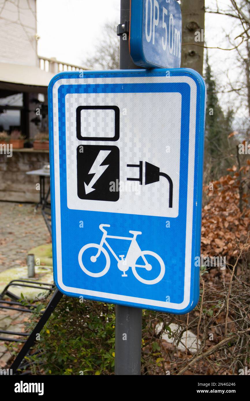 GERAARDSBERGEN, BELGIEN, 22. JANUAR 2023: E-Bike Charging Station Schild in Flandern Belgien. Beispiel für ein international anerkanntes Informationssig Stockfoto