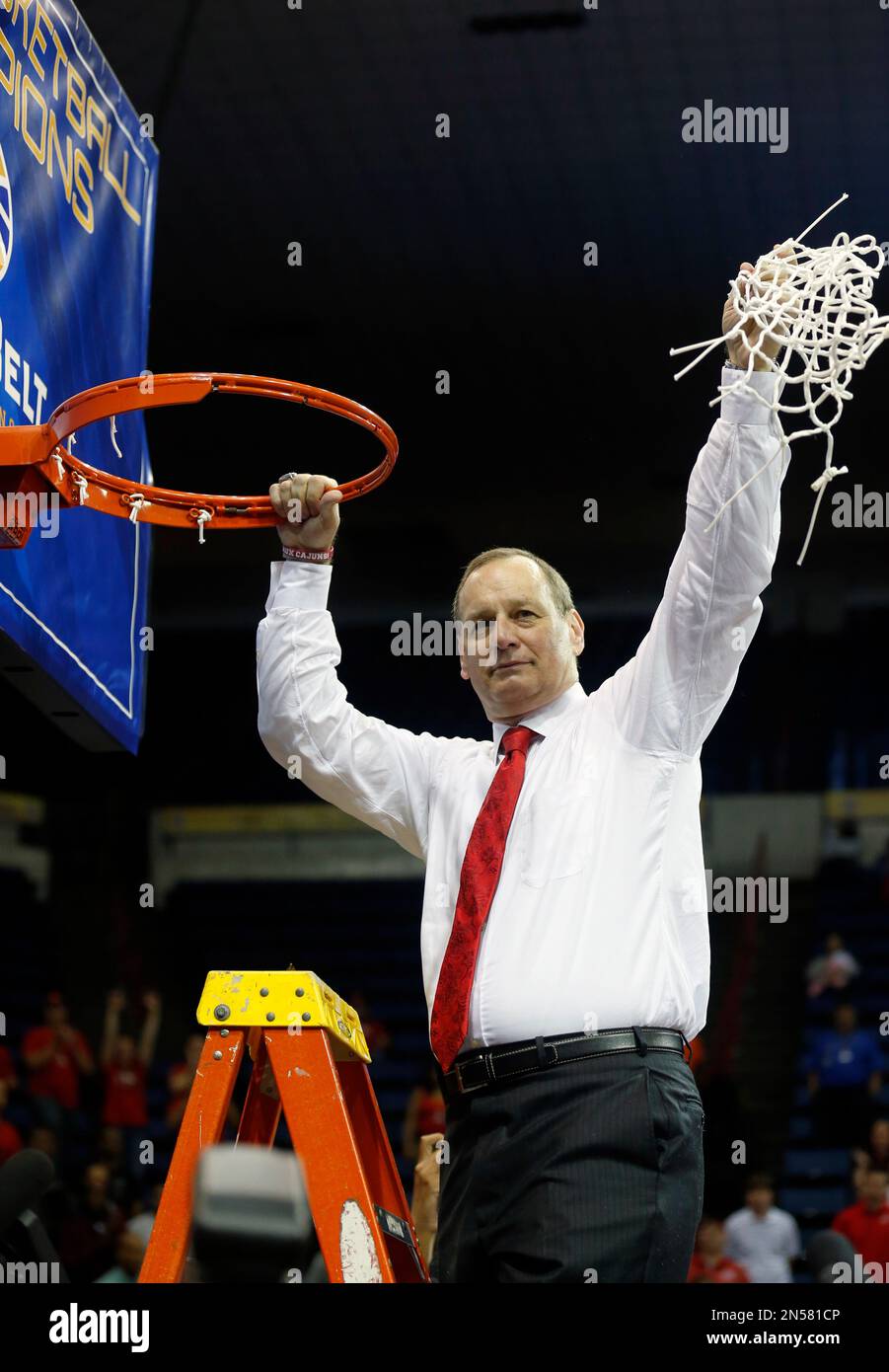 Louisiana Lafayette head coach Bob Marlin waves the net in victory