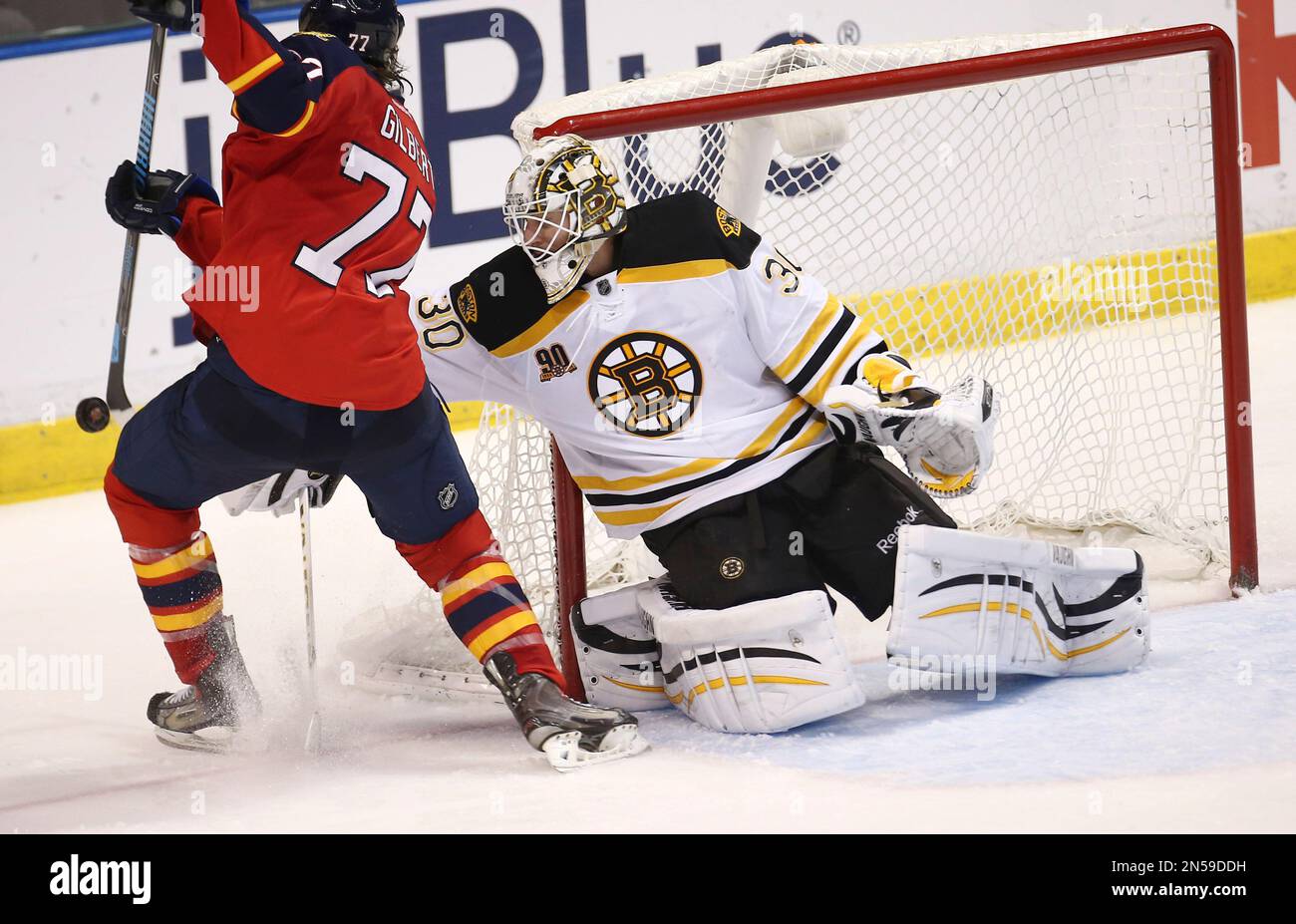 Boston Bruins goalie Chad Johnson (30) blocks a shot by Florida Panthers' Tom Gilbert (77) during the third period of an NHL hockey game in Sunrise, Fla., Sunday, March 9, 2014. Boston won 5-2. (AP Photo/J Pat Carter) Stockfoto