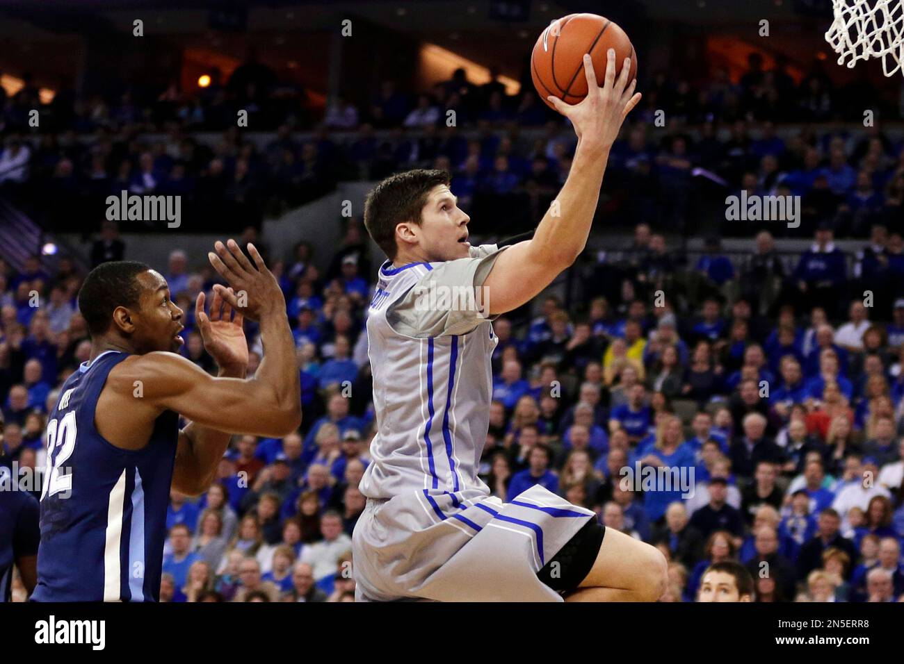 Creighton's Doug McDermott, right, goes for a layup past Villanova's