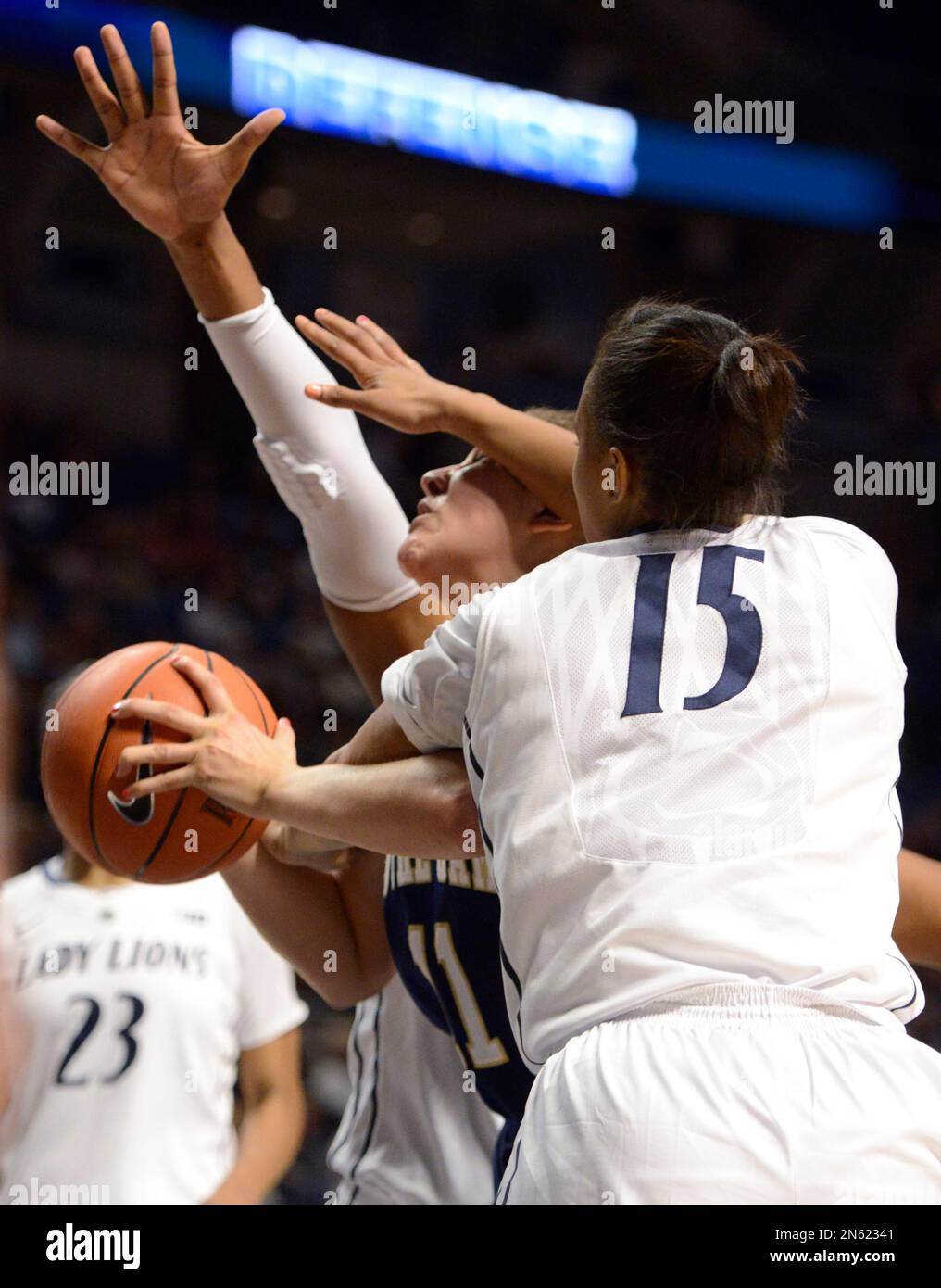 Notre Dame forward Natalie Achonwa (11) is fouled by Penn State's Kaliyah Mitchell (15) in the second half of an NCAA college basketball game on Wednesday, Dec. 4, 2013, in State College, Pa. Notre Dame defeated Penn State 77-67. (AP Photo/John Beale) Stockfoto