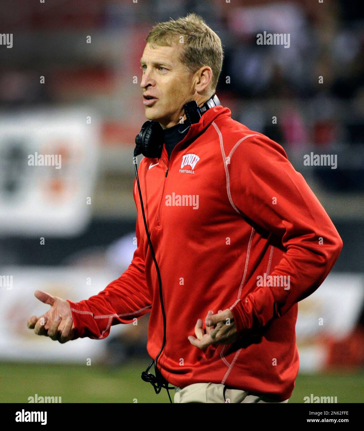 UNLV coach Bobby Hauck runs across the field after checking on a player