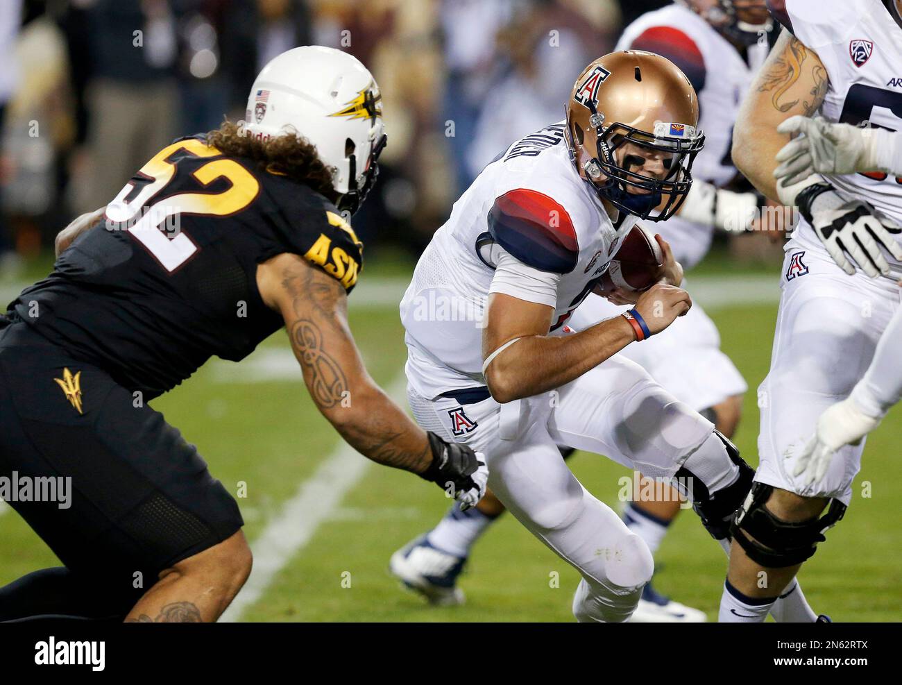 Arizona State's Carl Bradford (52) gets ready to sack Arizona's B.J. Denker during the first half of an NCAA college football game Saturday, Nov. 30, 2013, in Tempe, Ariz. (AP Photo/Ross D. Franklin) Stockfoto