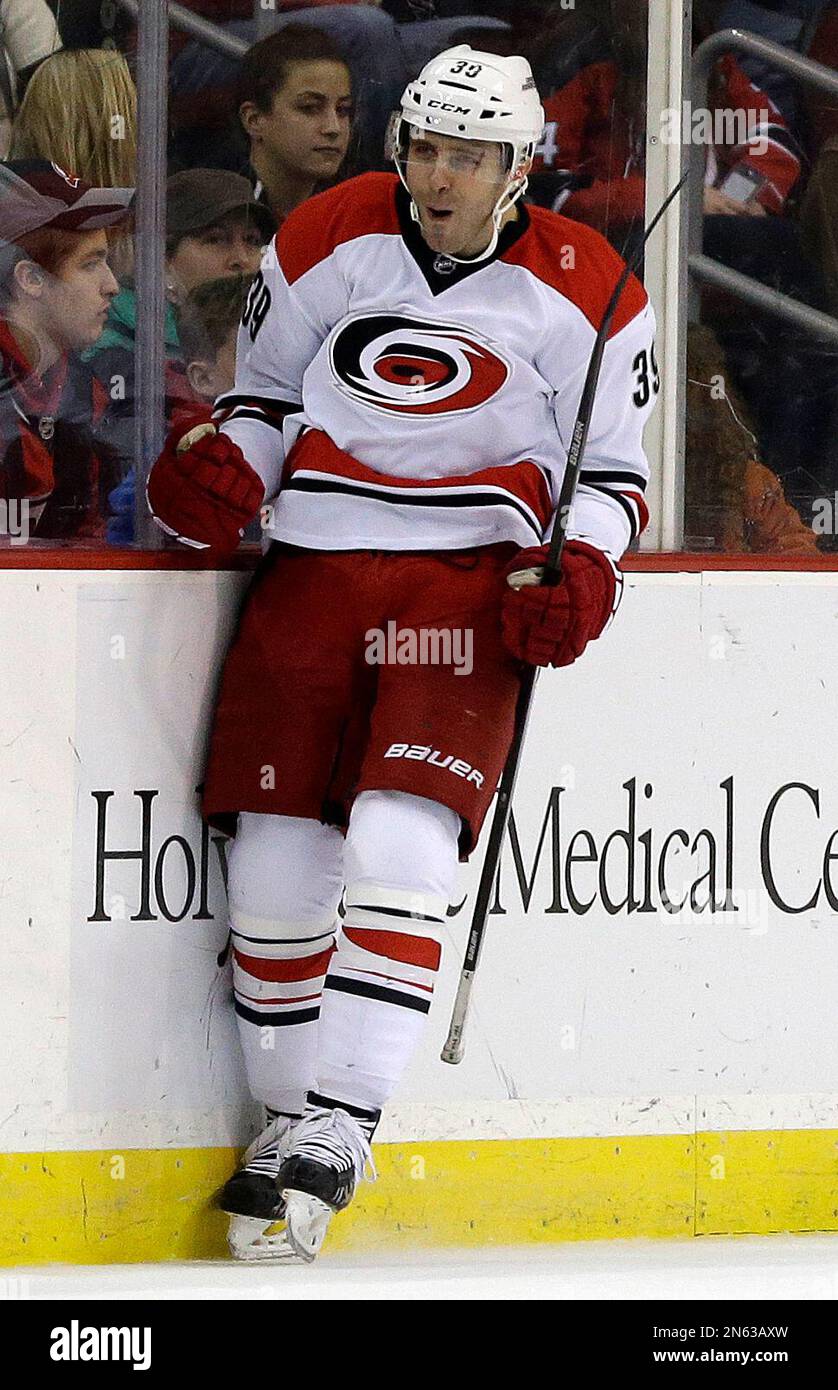 Carolina Hurricanes right wing Patrick Dwyer celebrates after scoring a goal on the New Jersey Devils during the second period of an NHL hockey game on Wednesday, Nov. 27, 2013, in Newark, N.J. (AP Photo/Julio Cortez) Stockfoto